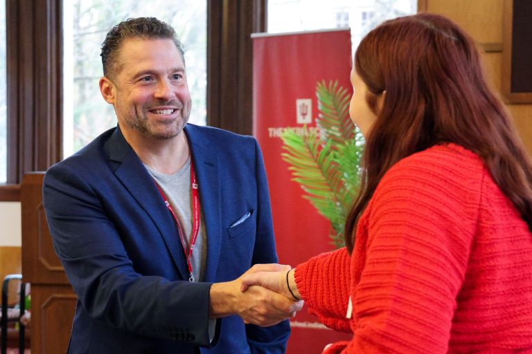 Two people shake hands.